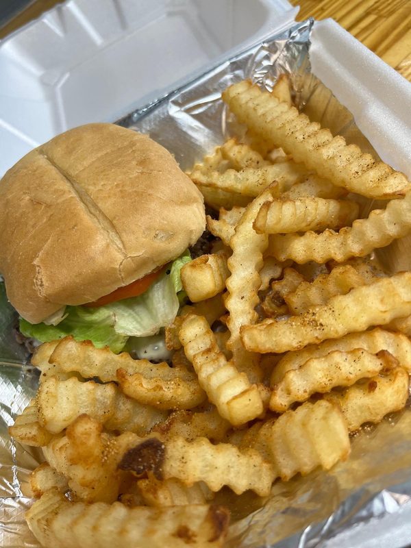 Cheeseburger with lettuce and tomato plus seasoned crinkle-cut fries